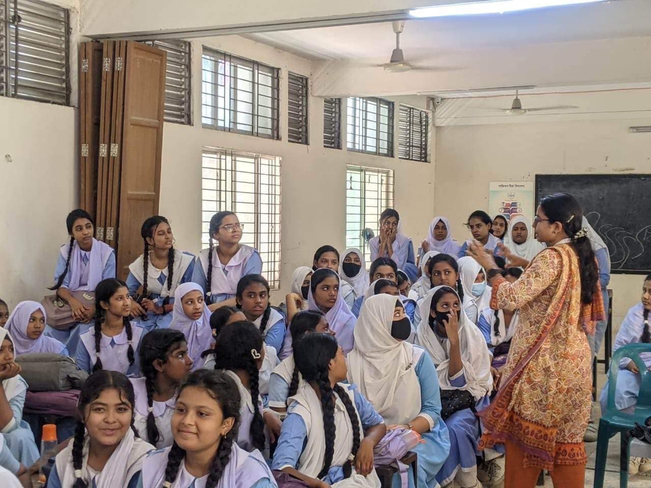 Shaathi field workers raising menstrual hygiene awareness door to door in Bangladesh